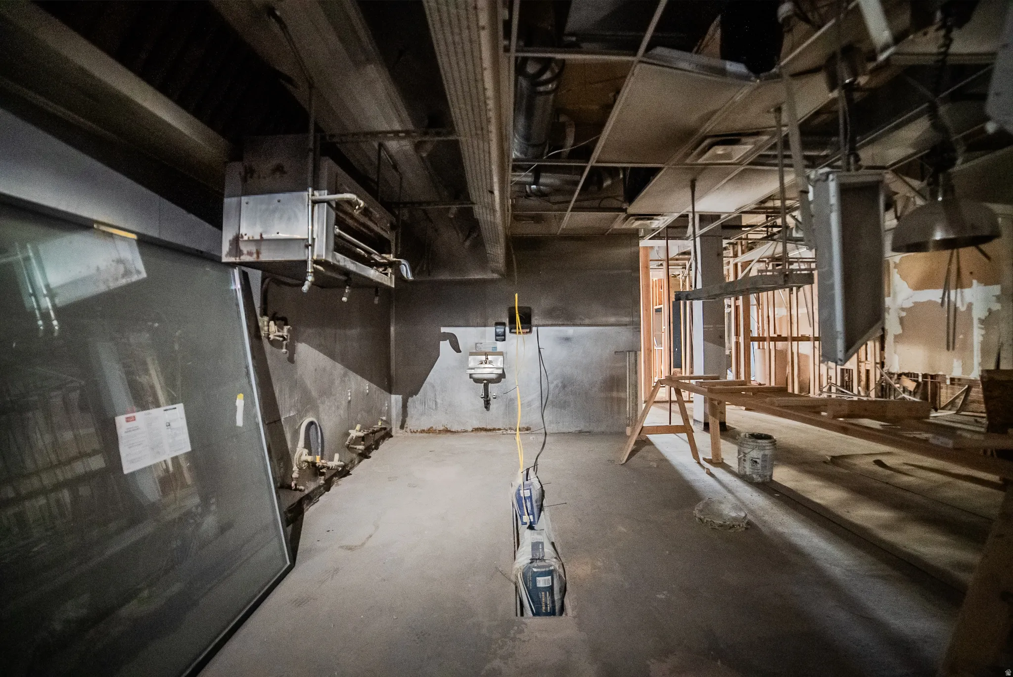 Unfinished below grade area with a heating unit