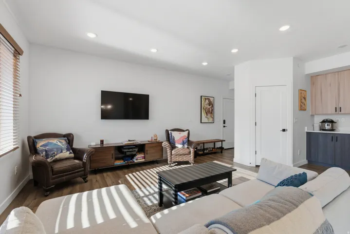 Living area featuring dark wood finished floors and recessed lighting