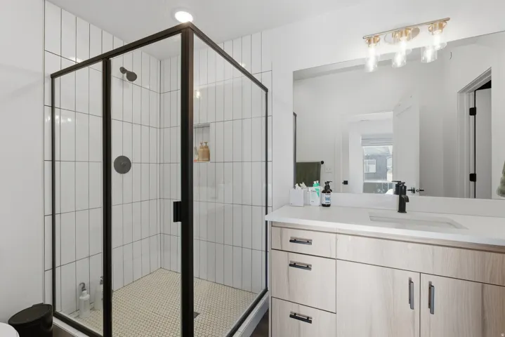Full bathroom featuring vanity and a shower stall