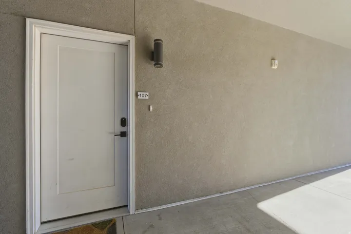 Doorway to property featuring stucco siding