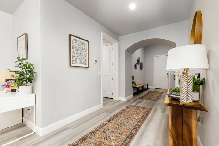 Entry way featuring arched walkways and light wood finished floors