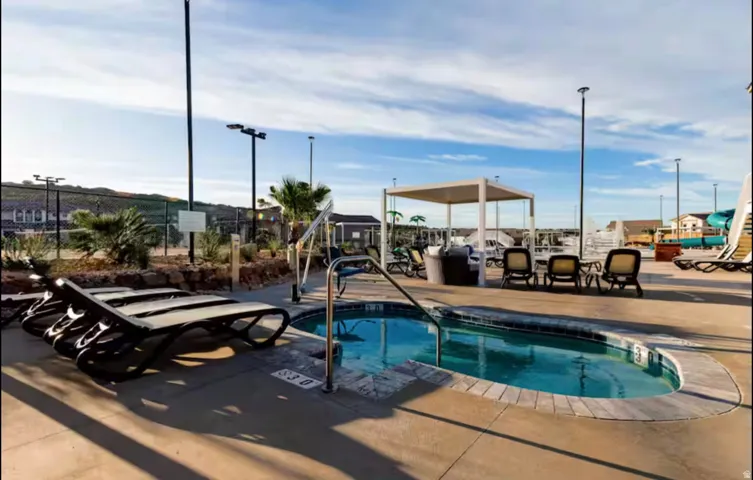 View of pool with a community hot tub