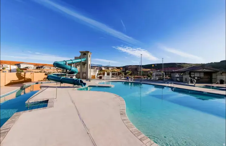 Community pool featuring a water slide and lazy river