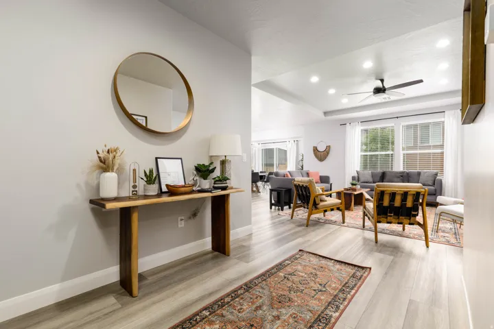Entryway with recessed lighting, a raised ceiling, light wood-style floors, and ceiling fan