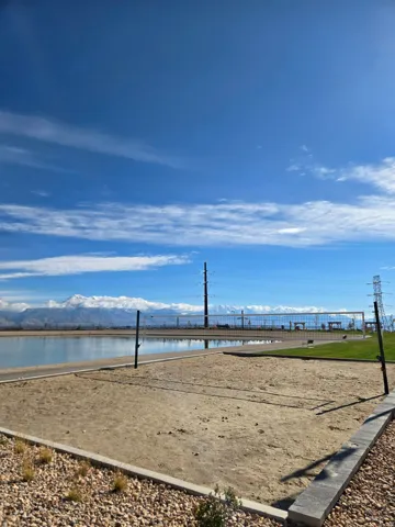 View of home's community featuring volleyball court and a water and mountain view