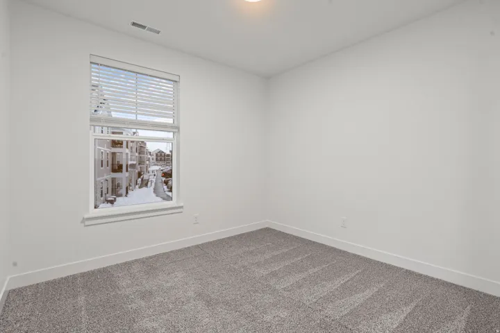 Carpeted empty room featuring baseboards