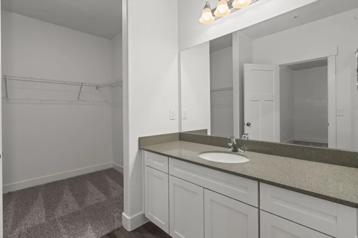 Full bath with a spacious closet and vanity