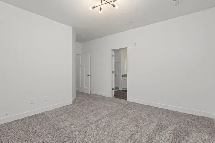 Carpeted empty room with baseboards