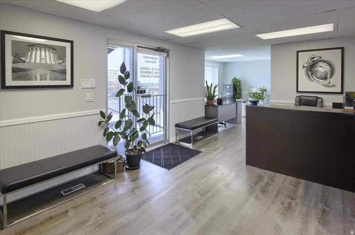 Welcome area featuring wainscoting and a drop ceiling