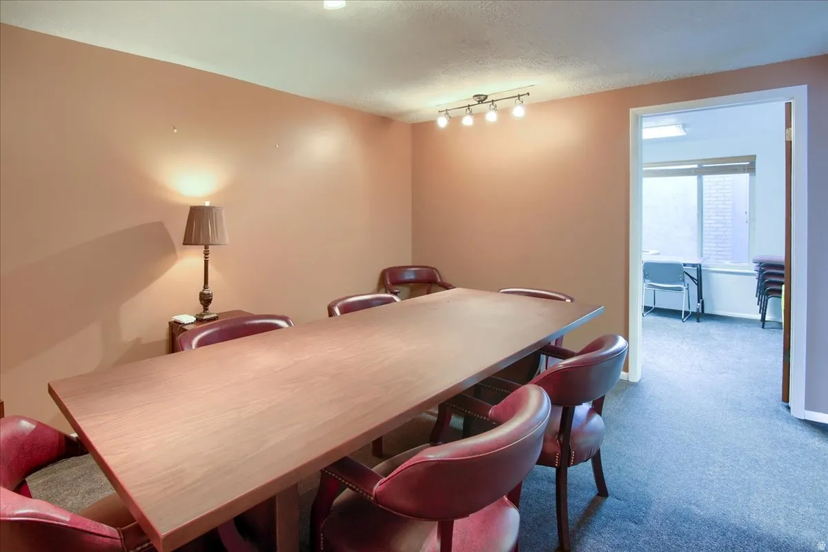Dining room with carpet floors and a textured ceiling