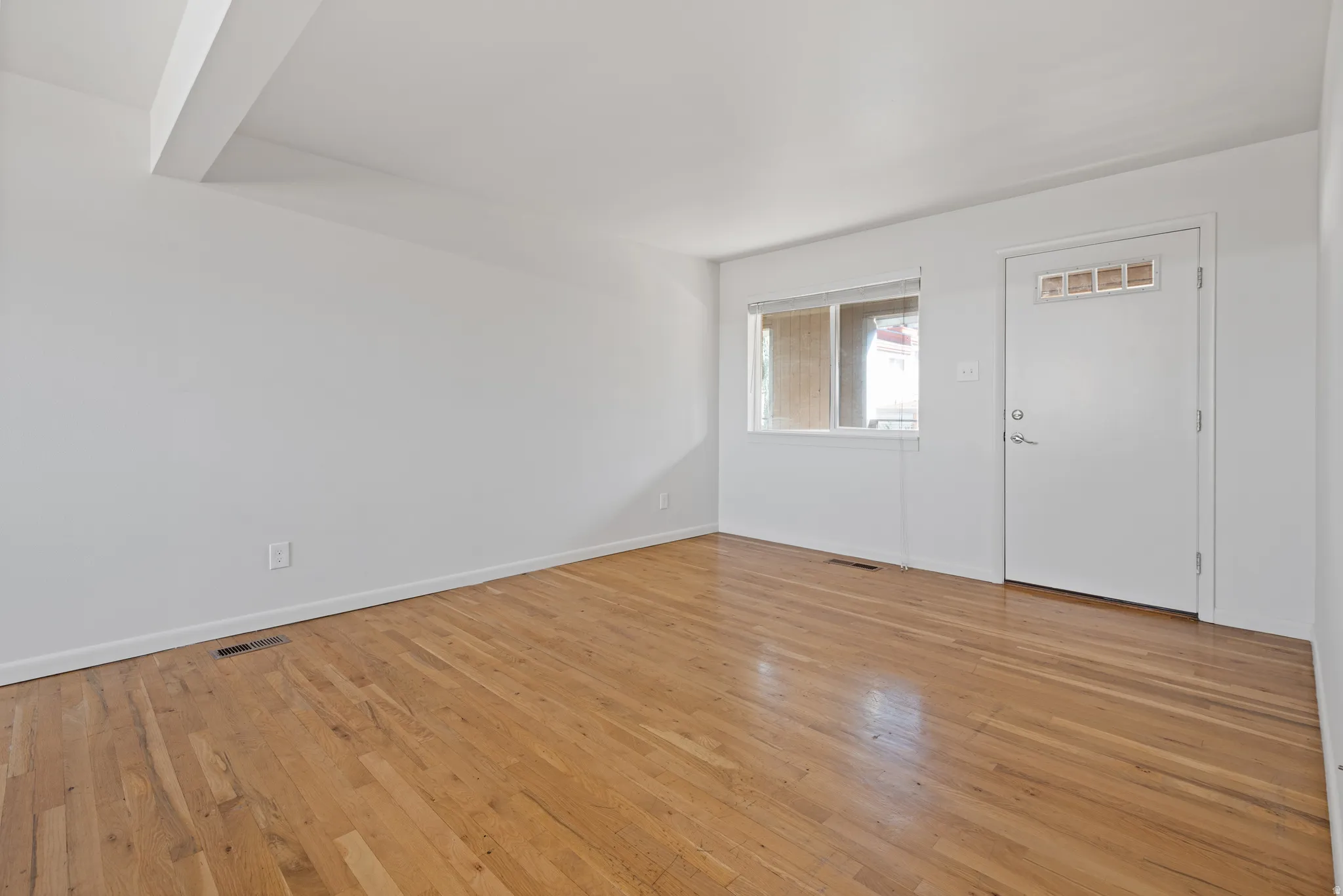 Entryway with light wood-style floors and baseboards