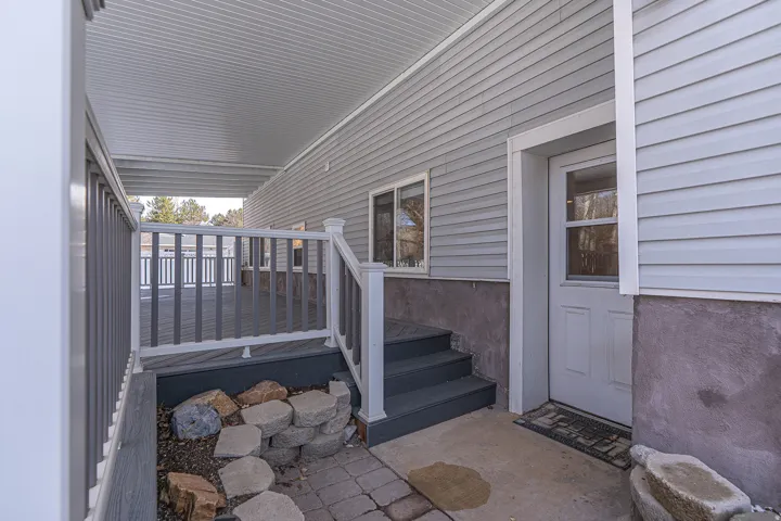 Entrance to property featuring a deck