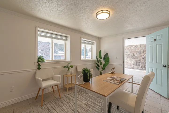 Dining area with a textured ceiling and crown molding