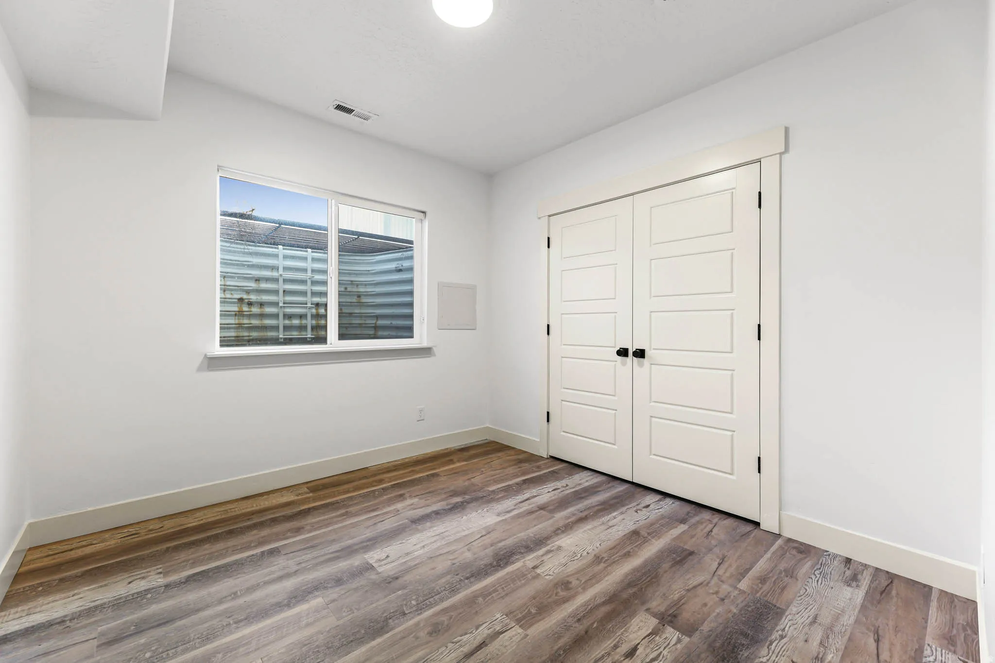Unfurnished bedroom with a closet and wood finished floors