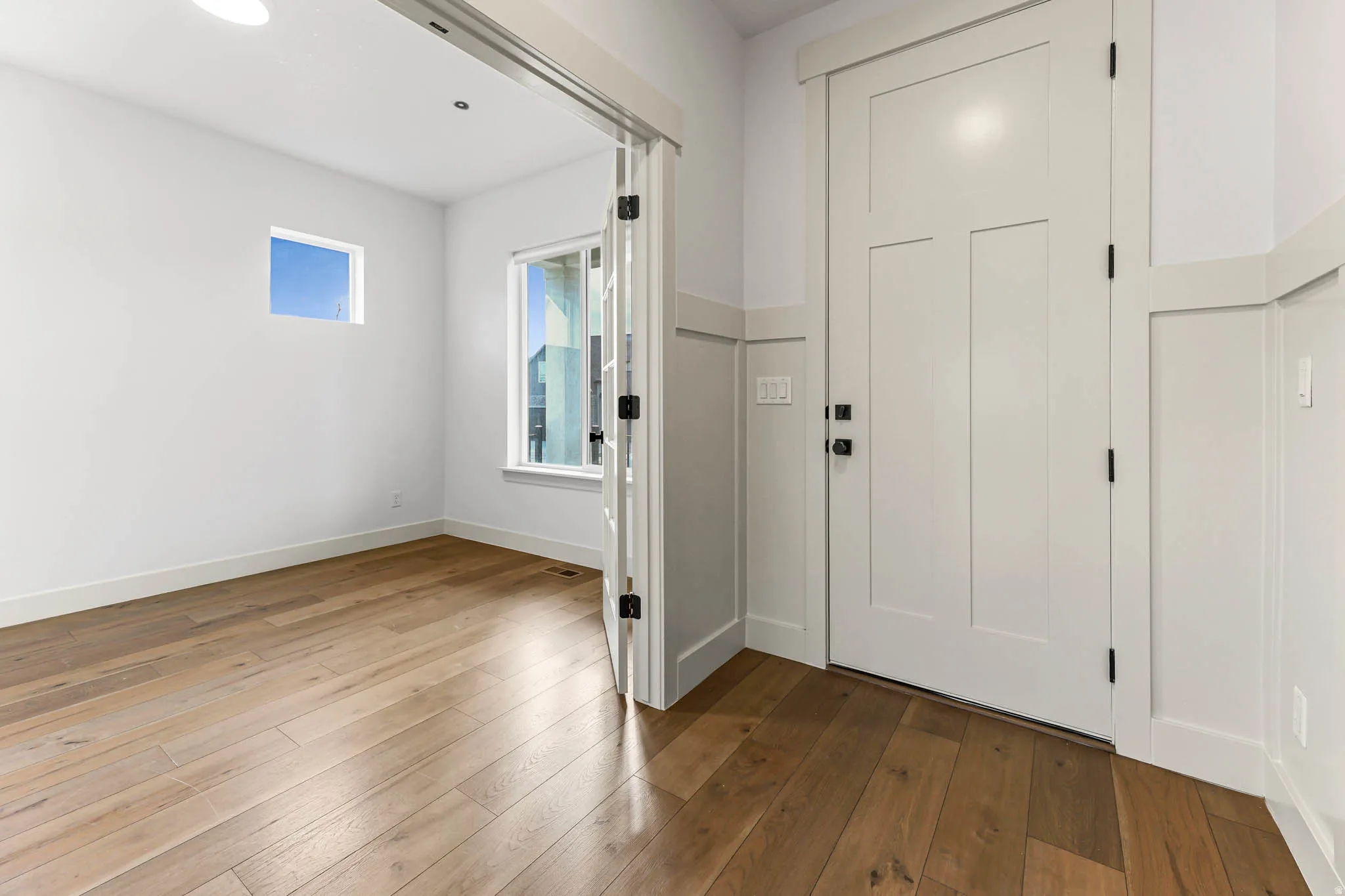 Entryway featuring hardwood / wood-style floors and baseboards