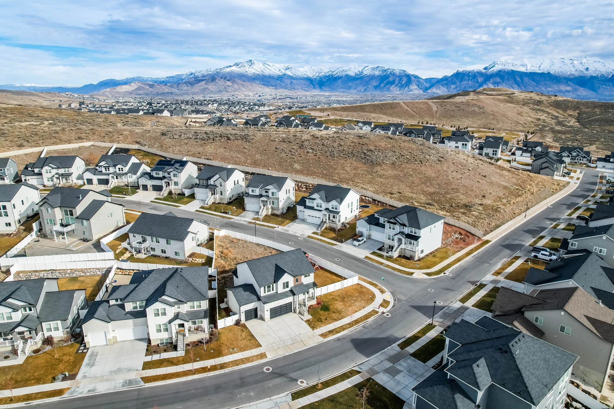 Aerial perspective of suburban area featuring a mountainous background