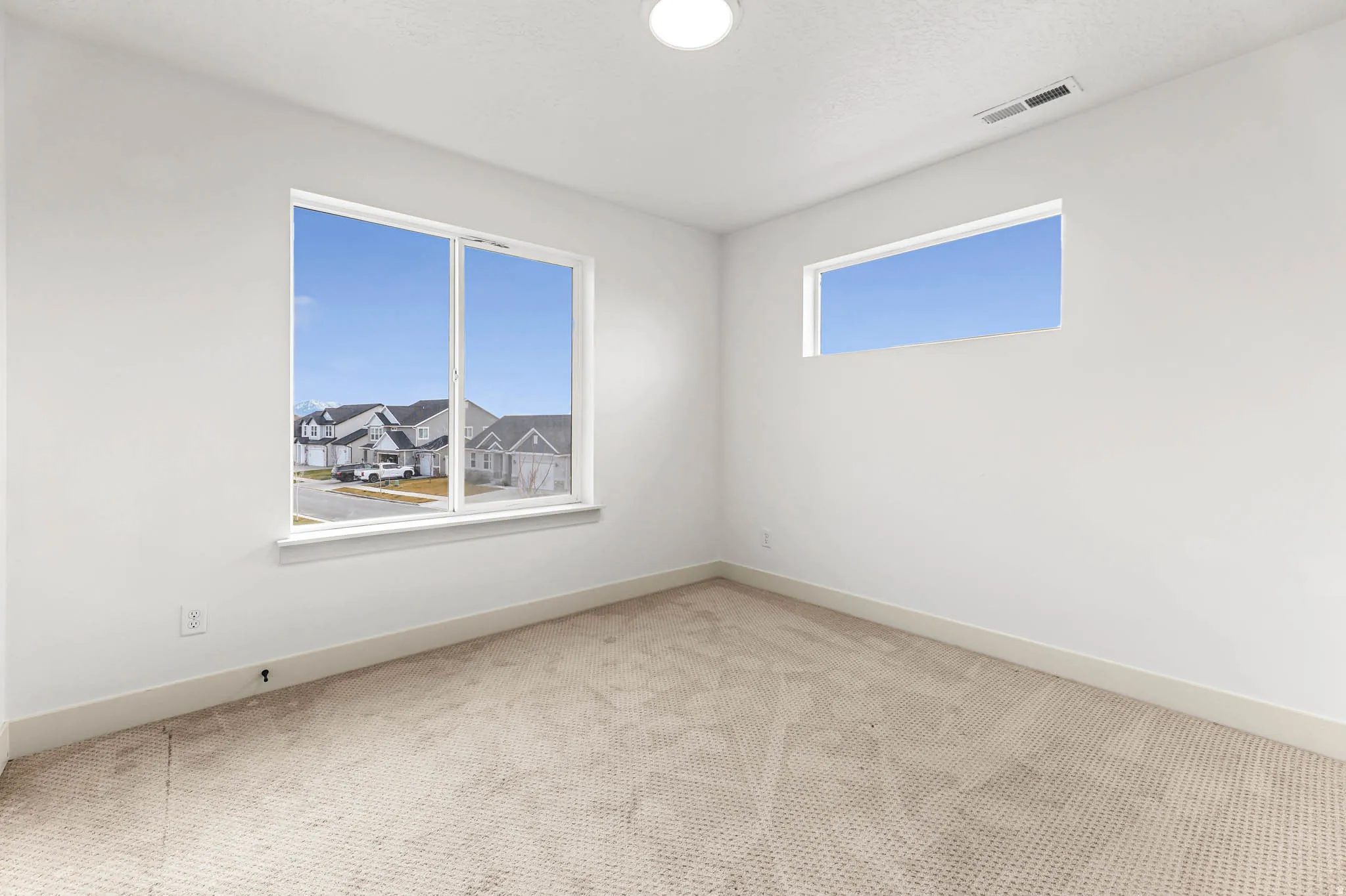 Carpeted empty room with baseboards