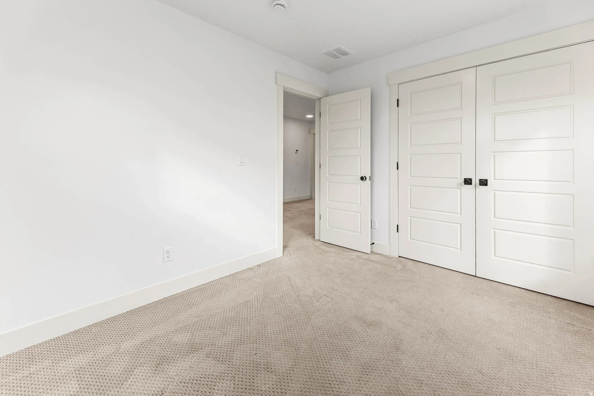 Unfurnished bedroom featuring carpet and a closet
