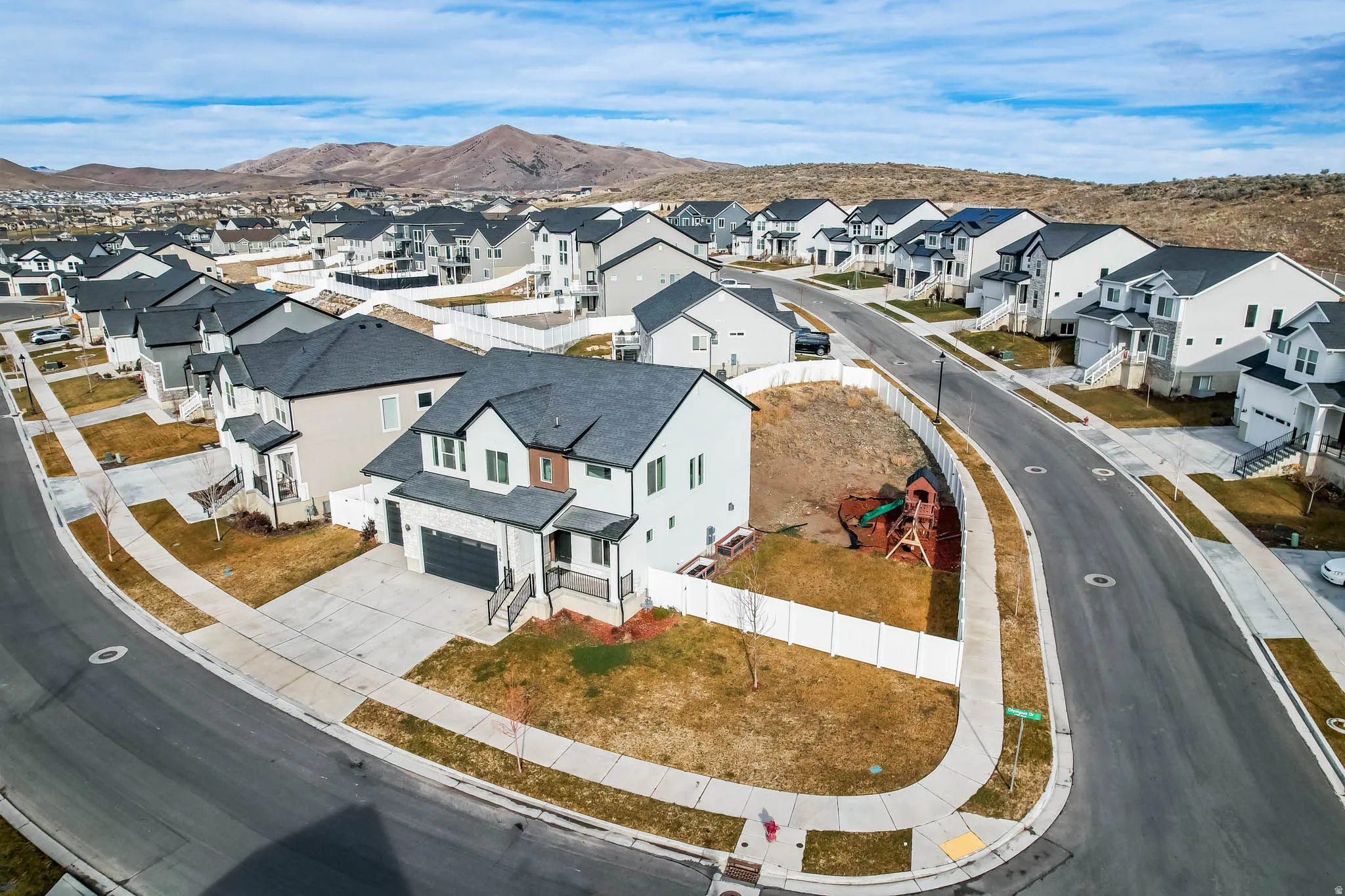 Aerial perspective of suburban area with a mountainous background