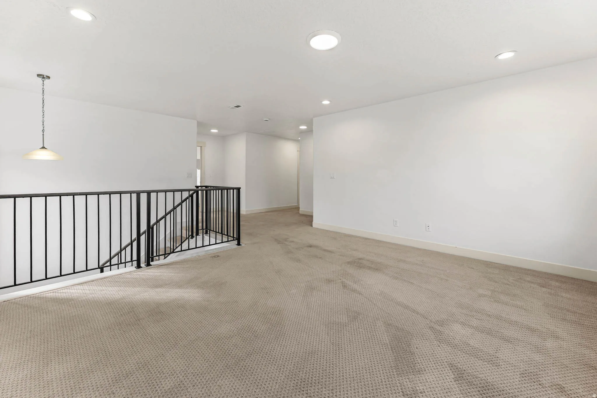 Unfurnished room with recessed lighting and light carpet