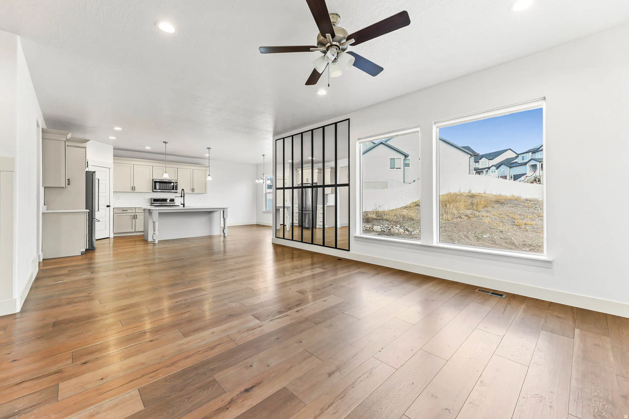 Unfurnished living room with recessed lighting, light wood finished floors, and ceiling fan