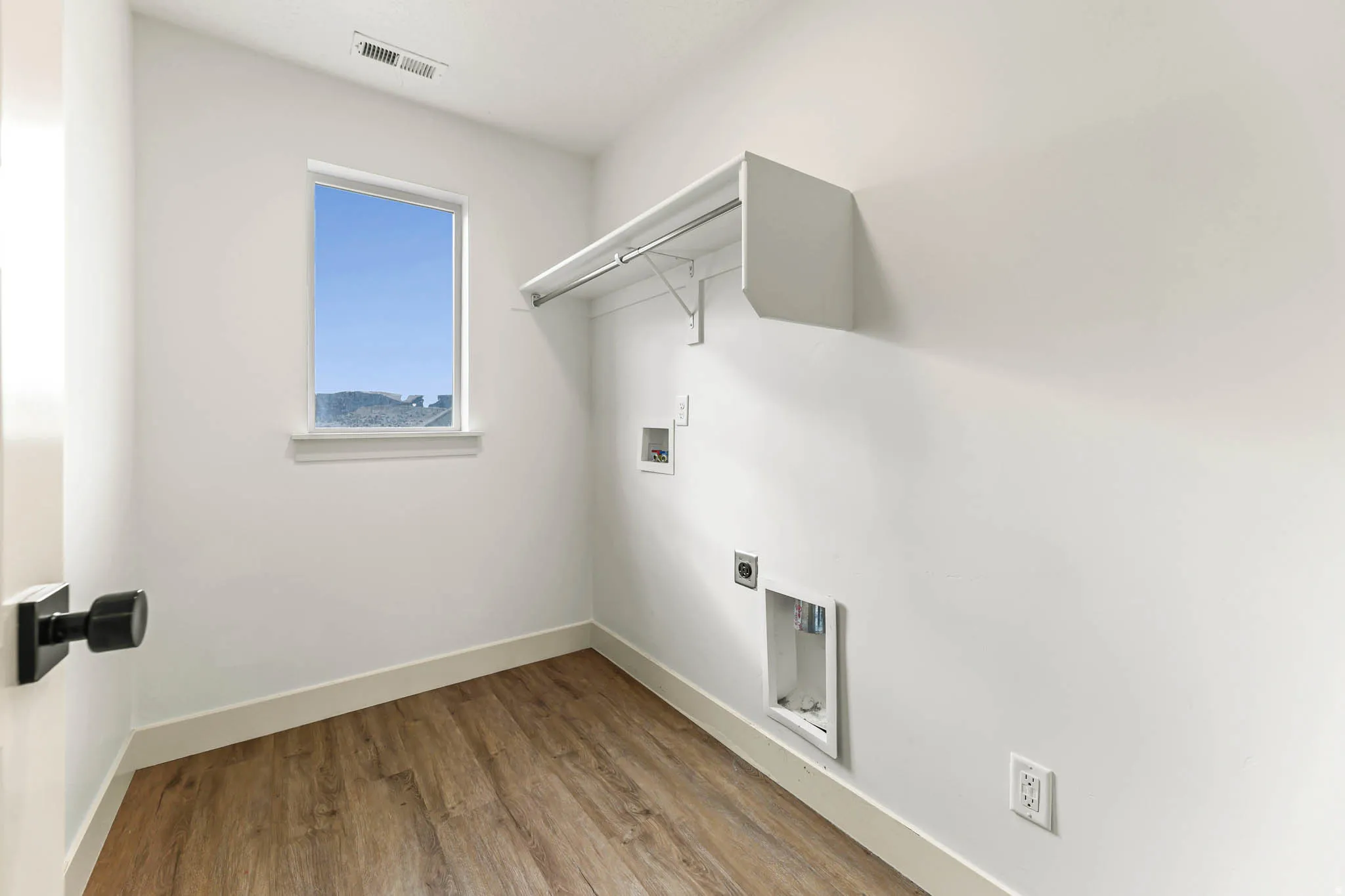Laundry room featuring light wood-style floors, washer hookup, and hookup for an electric dryer