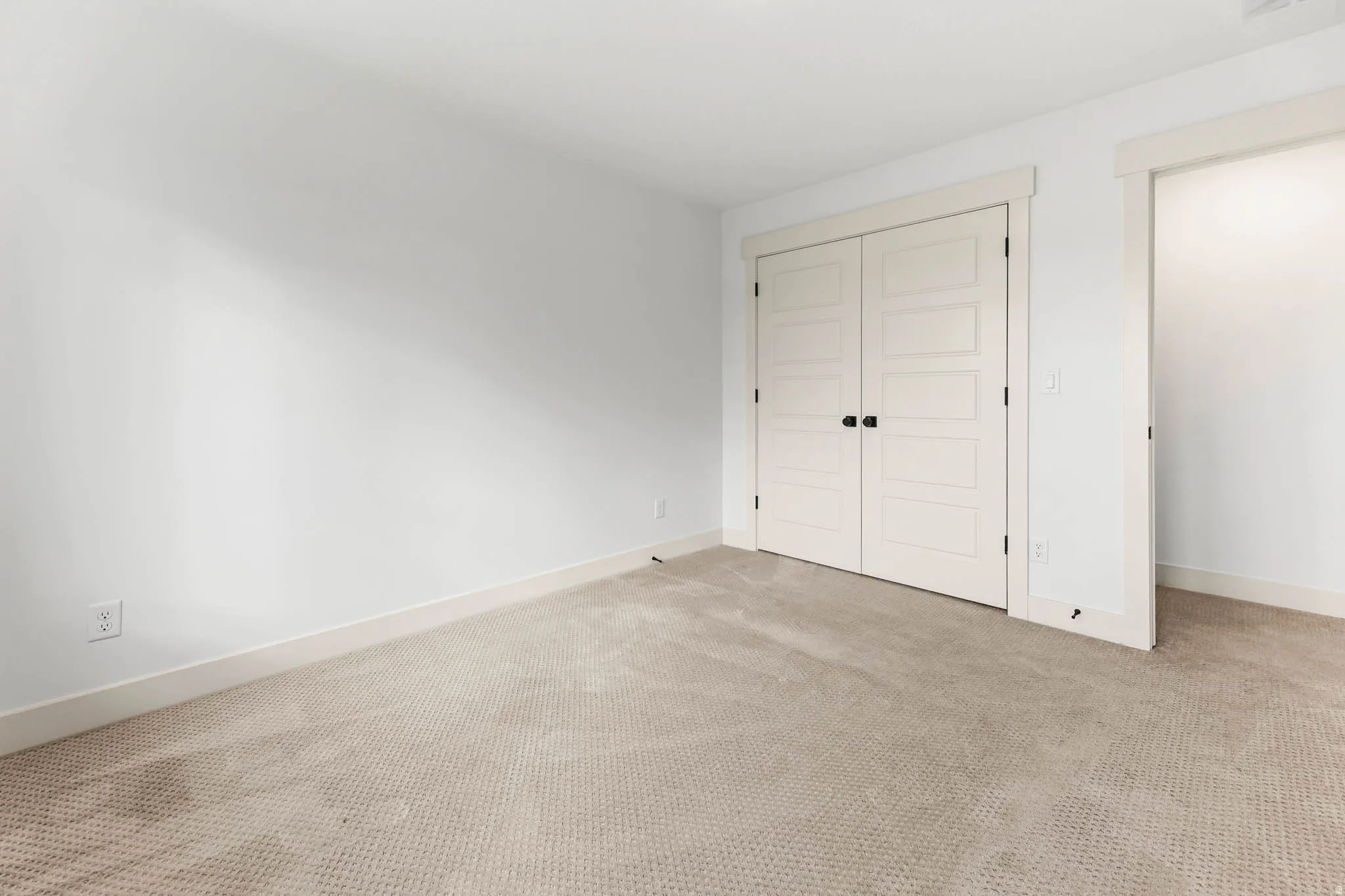 Unfurnished bedroom with carpet floors and a closet