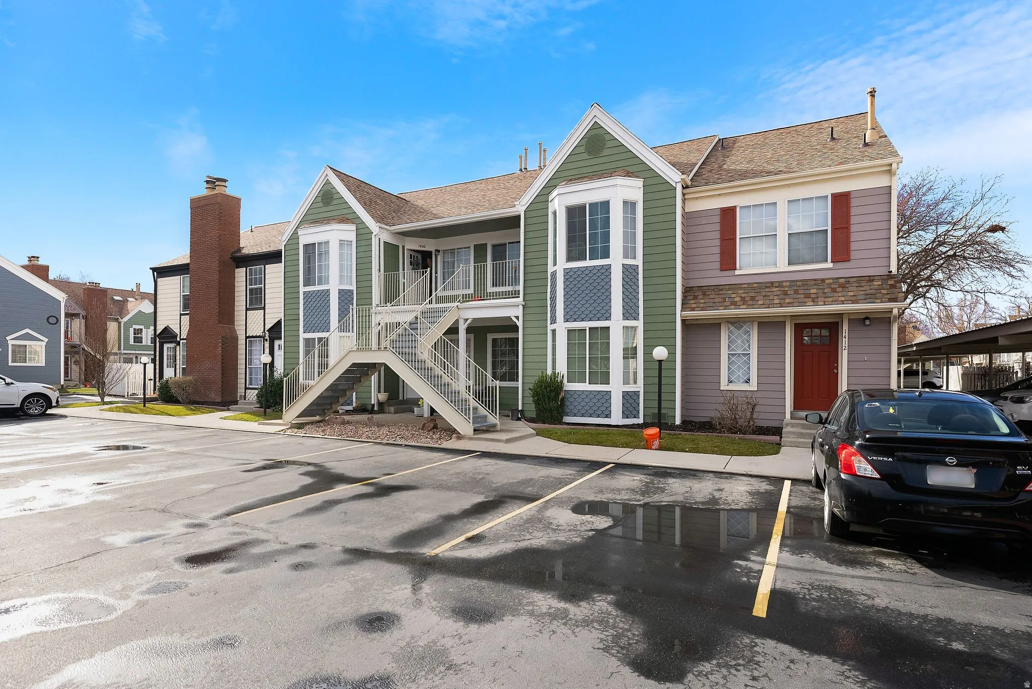 View of front of house with uncovered parking, stairs, a residential view, and roof with shingles