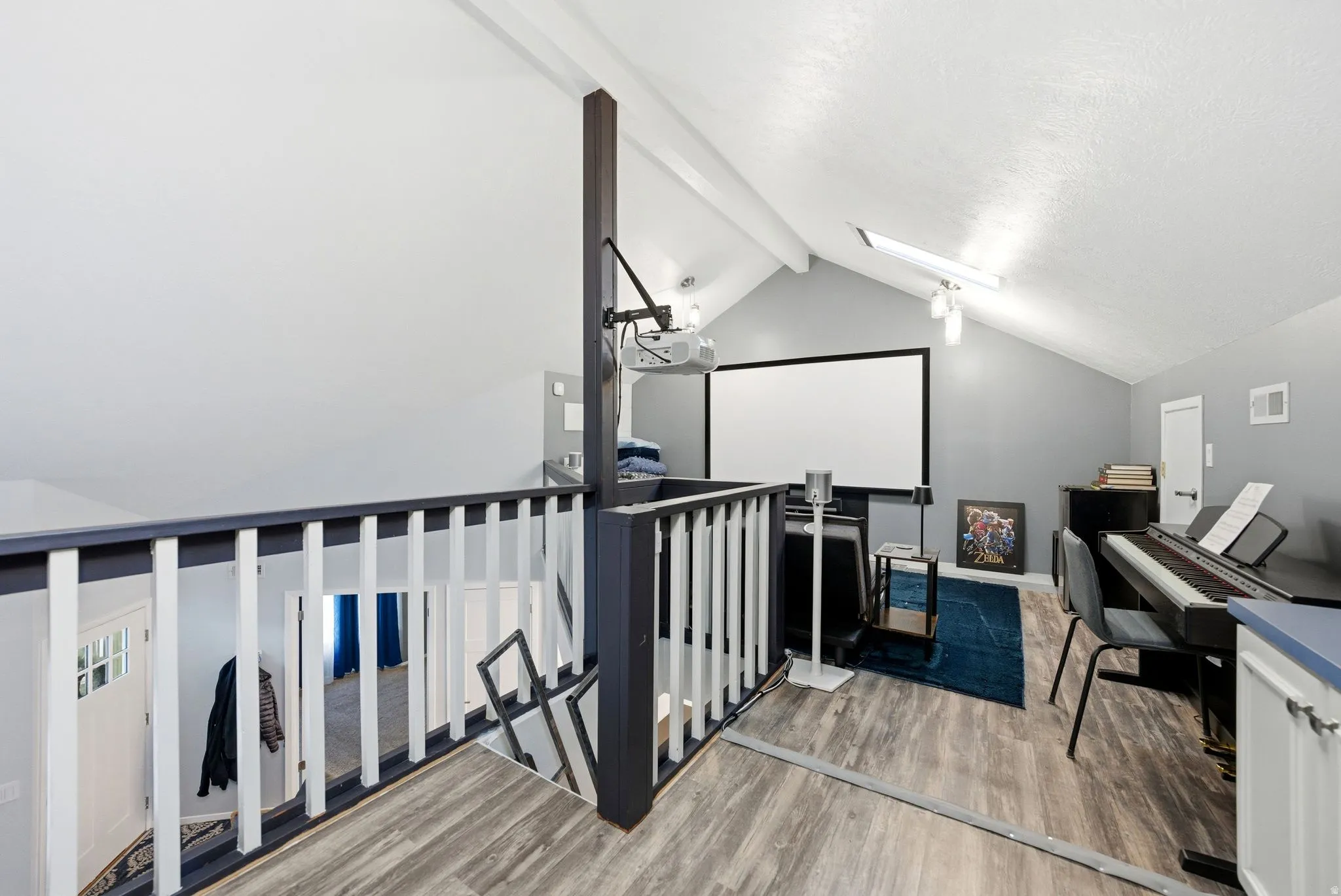 Cinema with a skylight and light wood-type flooring