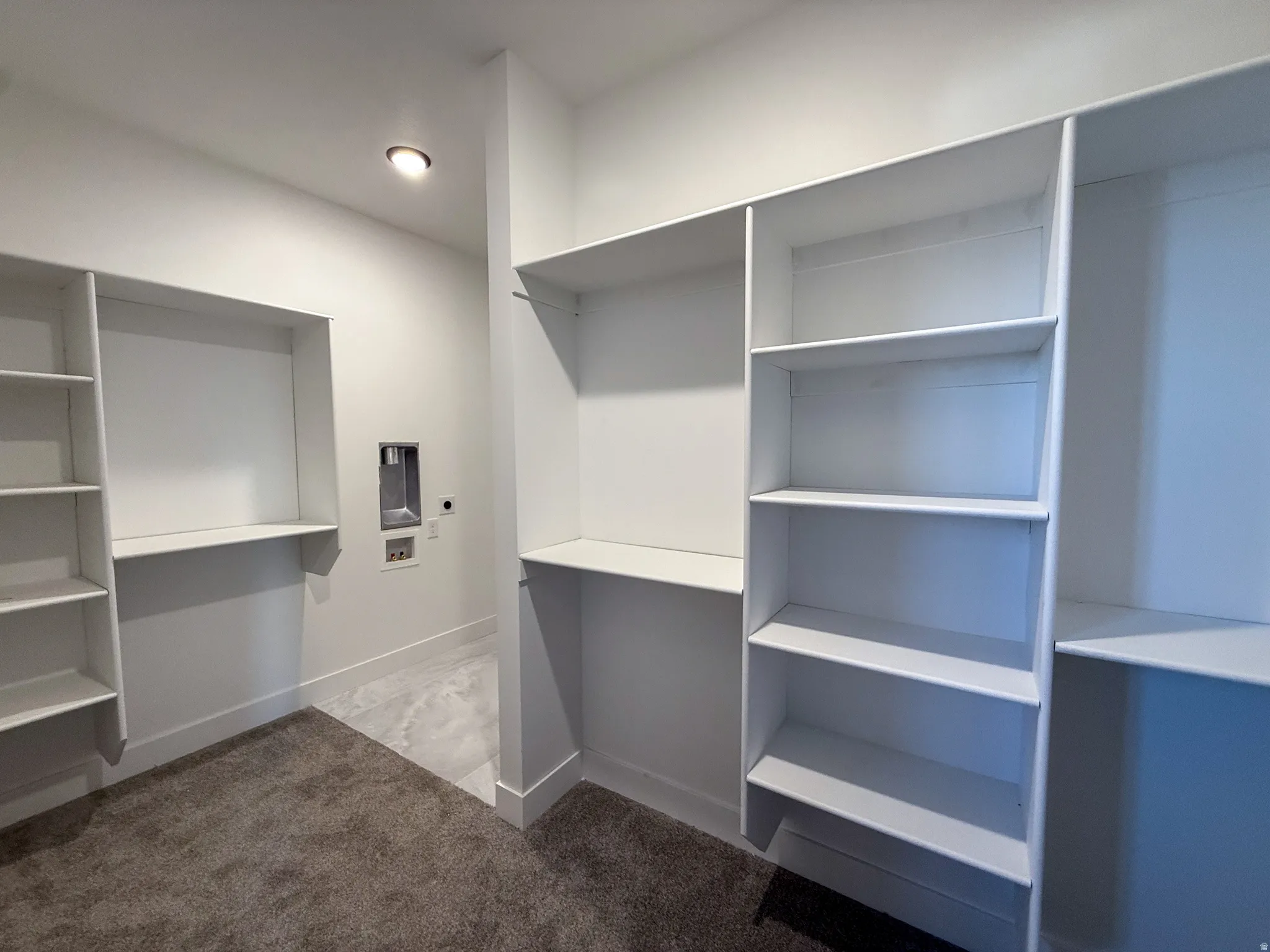 Walk in closet featuring dark carpet