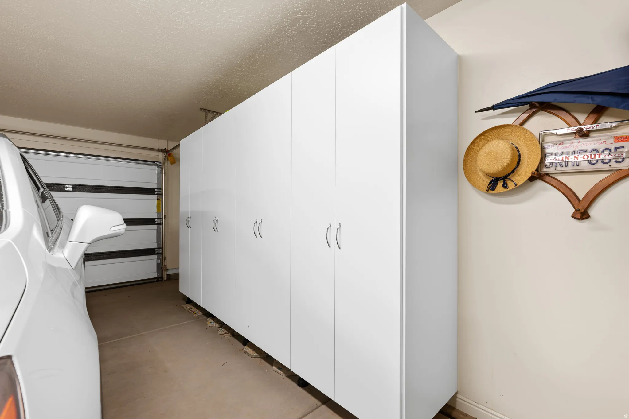 Hall with concrete flooring and a textured ceiling
