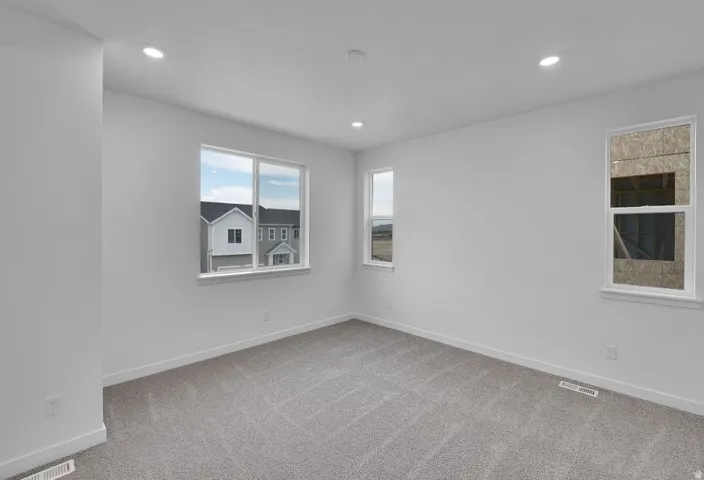 Spare room featuring light carpet and recessed lighting