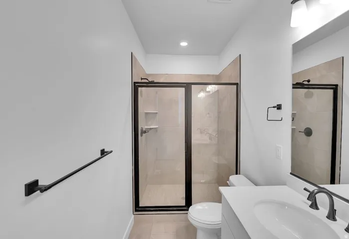 Full bathroom featuring a shower stall and vanity