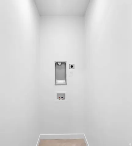 Washroom featuring hookup for an electric dryer, washer hookup, and light tile patterned flooring