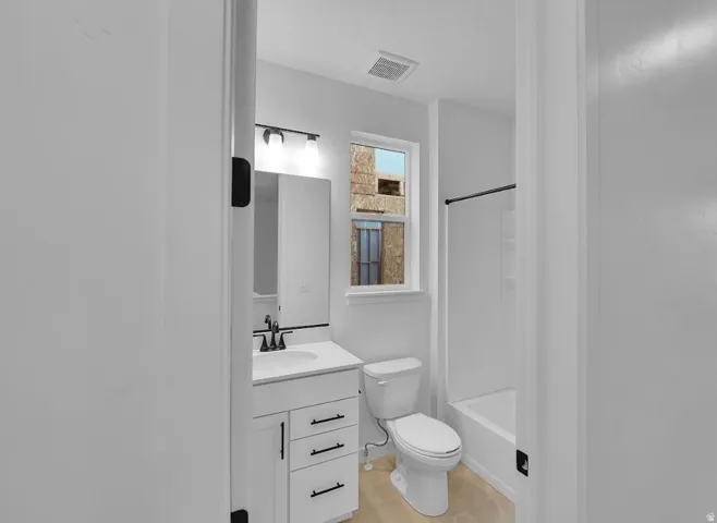 Bathroom with vanity,  shower combination, and light tile patterned flooring