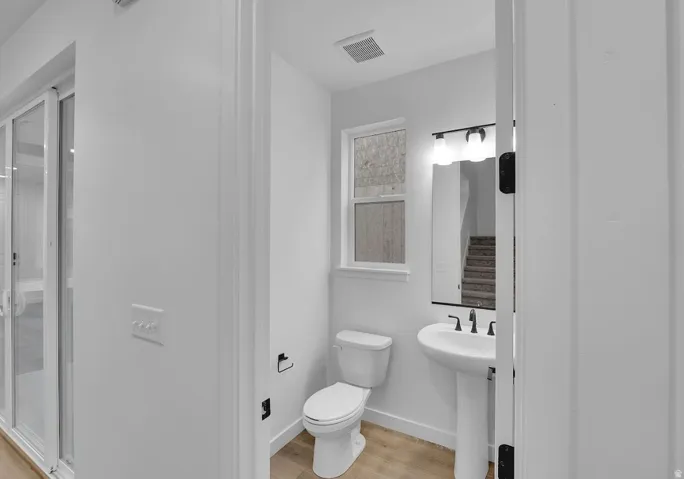 Bathroom featuring toilet and light wood-style floors