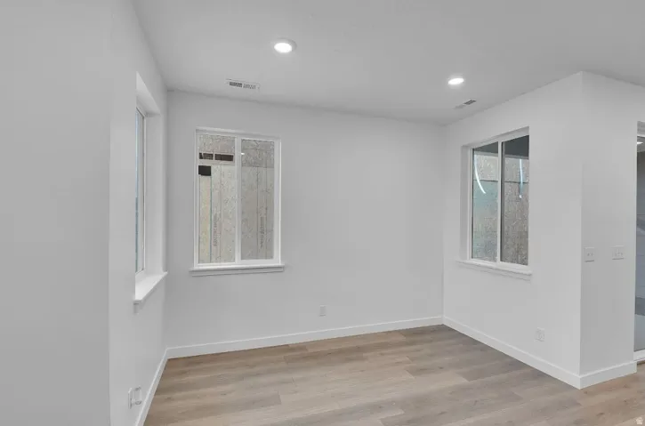 Unfurnished room with light wood-style flooring and recessed lighting