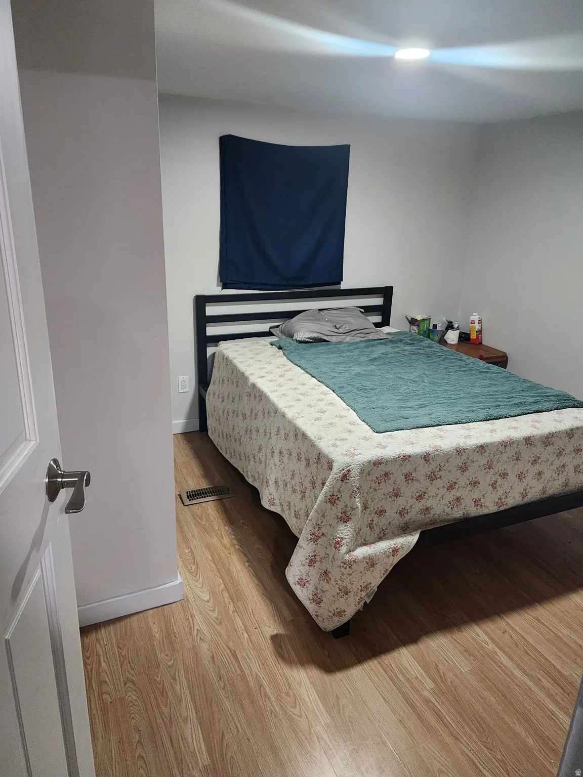 Bedroom with light wood-style floors and baseboards