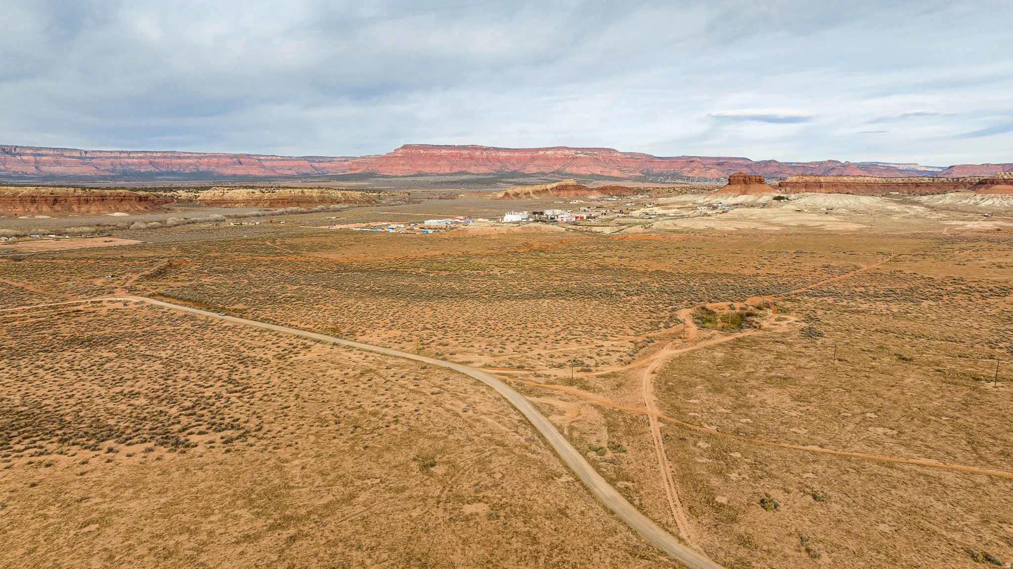 Aerial view of sparsely populated area featuring a desert landscape and a mountain backdrop