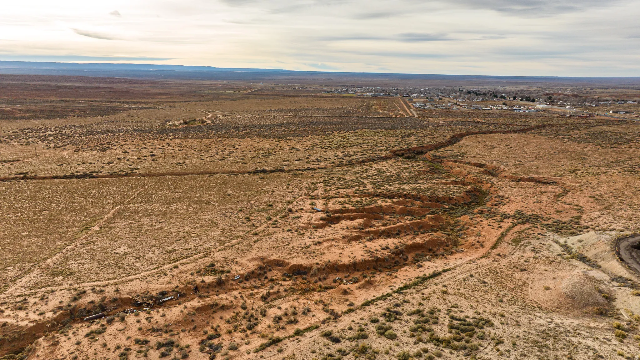 Aerial view of property's location with rural landscape and a mountain backdrop