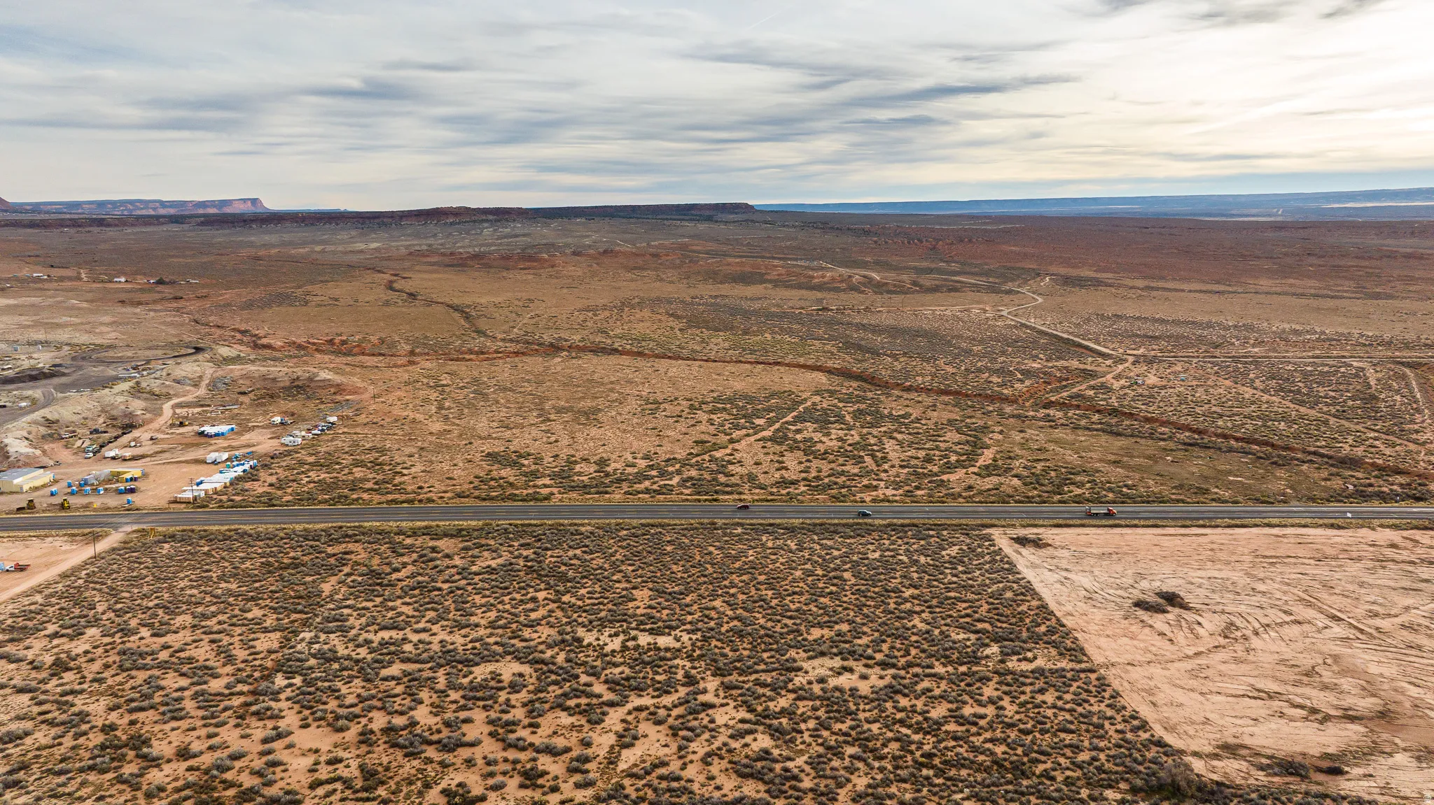 Overview of rural landscape featuring a desert landscape and a mountainous background