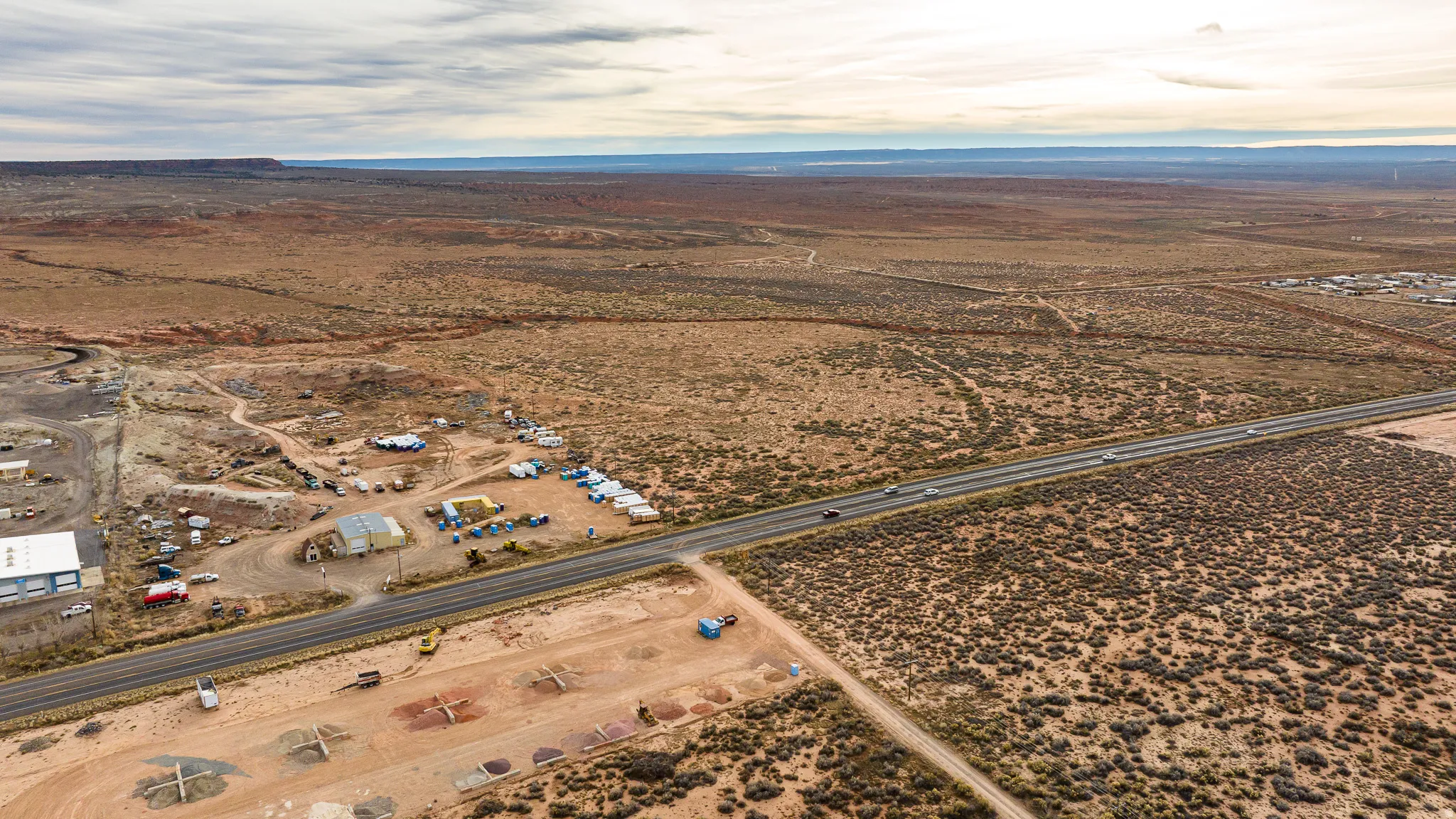 Aerial view of property's location with rural landscape and a mountain backdrop