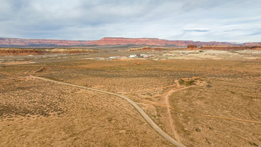 Aerial view of sparsely populated area featuring a desert landscape and a mountain backdrop