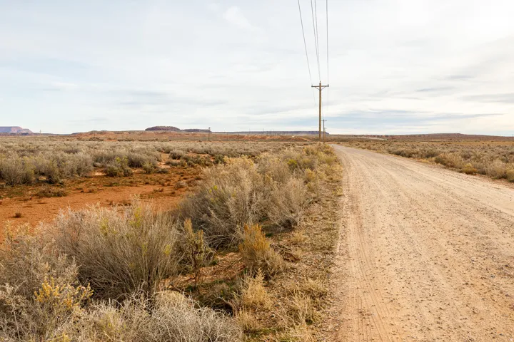 View of dirt / gravel road with a view of rural / pastoral area