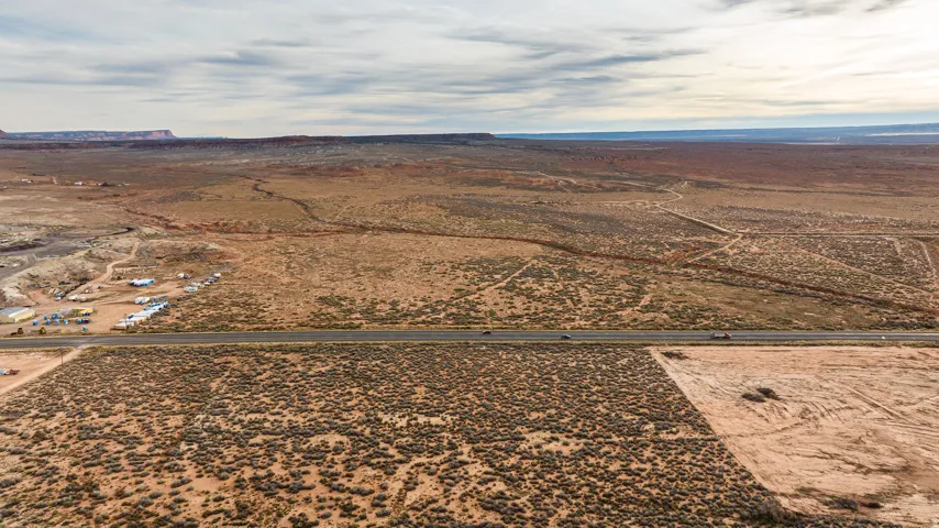 Overview of rural landscape featuring a desert landscape and a mountainous background