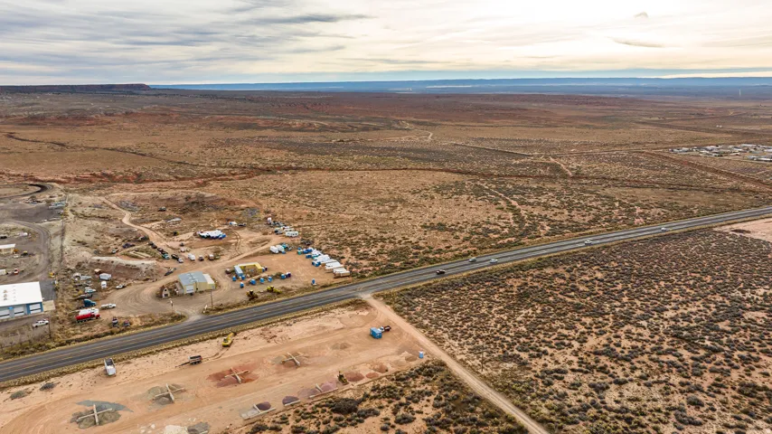 Aerial view of property's location with rural landscape and a mountain backdrop
