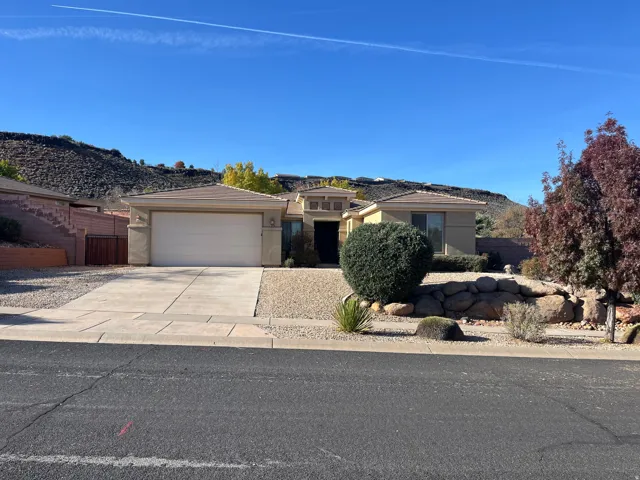 Prairie-style home with concrete driveway, stucco siding, a garage, and a mountain view