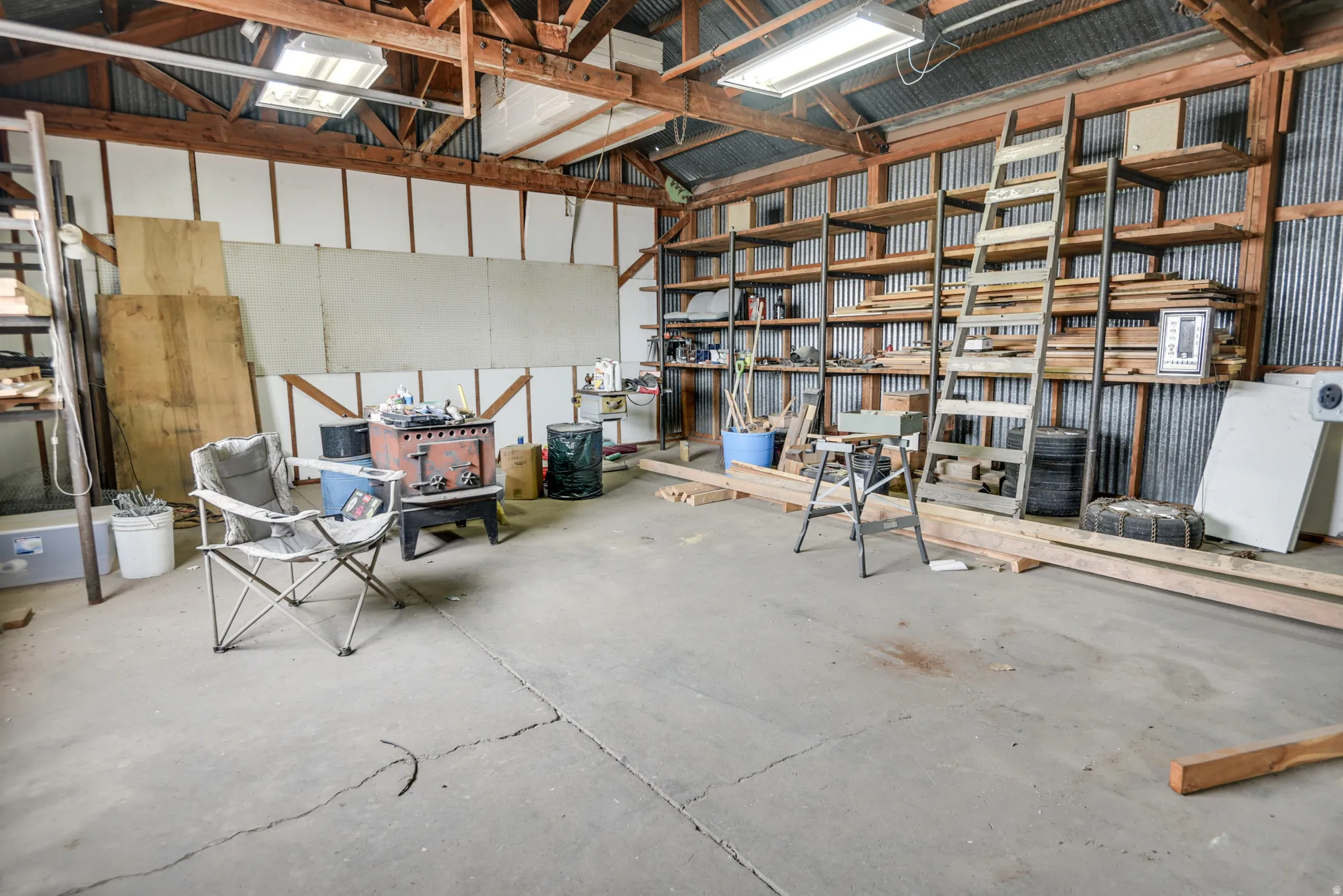 Garage with metal wall and white fridge