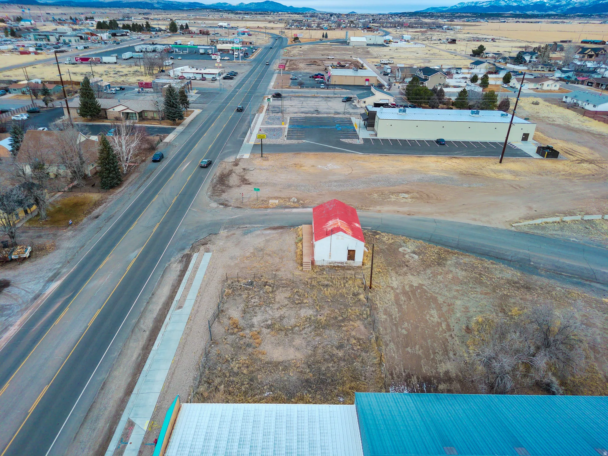 Bird's eye view of industrial structures and a mountain backdrop