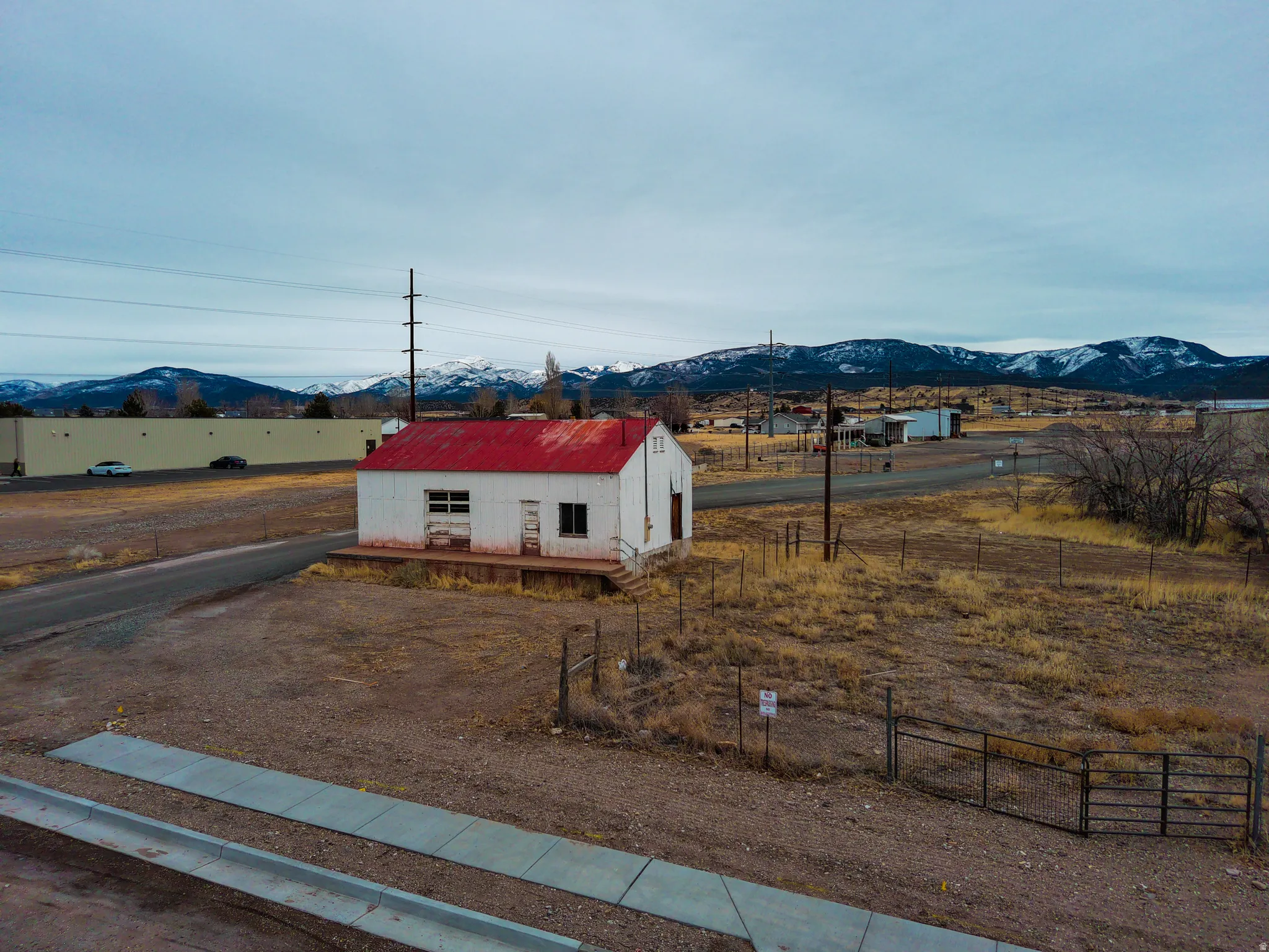 View of front of home with a mountain view and an outdoor structure
